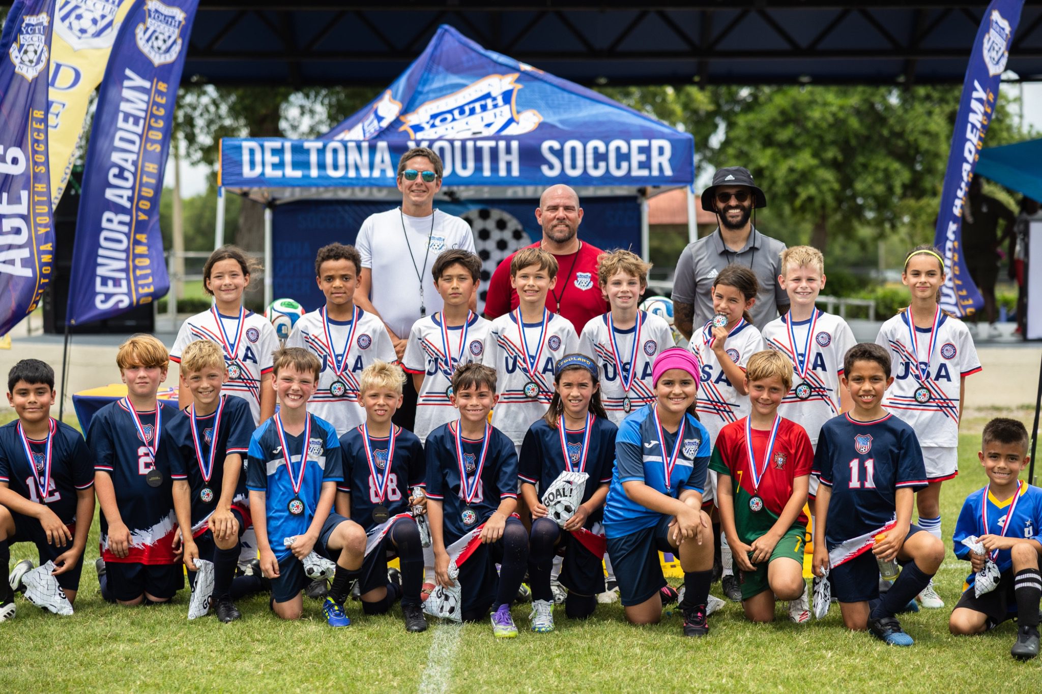 Youth soccer team poses with medals at Deltona Youth Soccer Club Recreation World Cup 2026 Deltona Florida